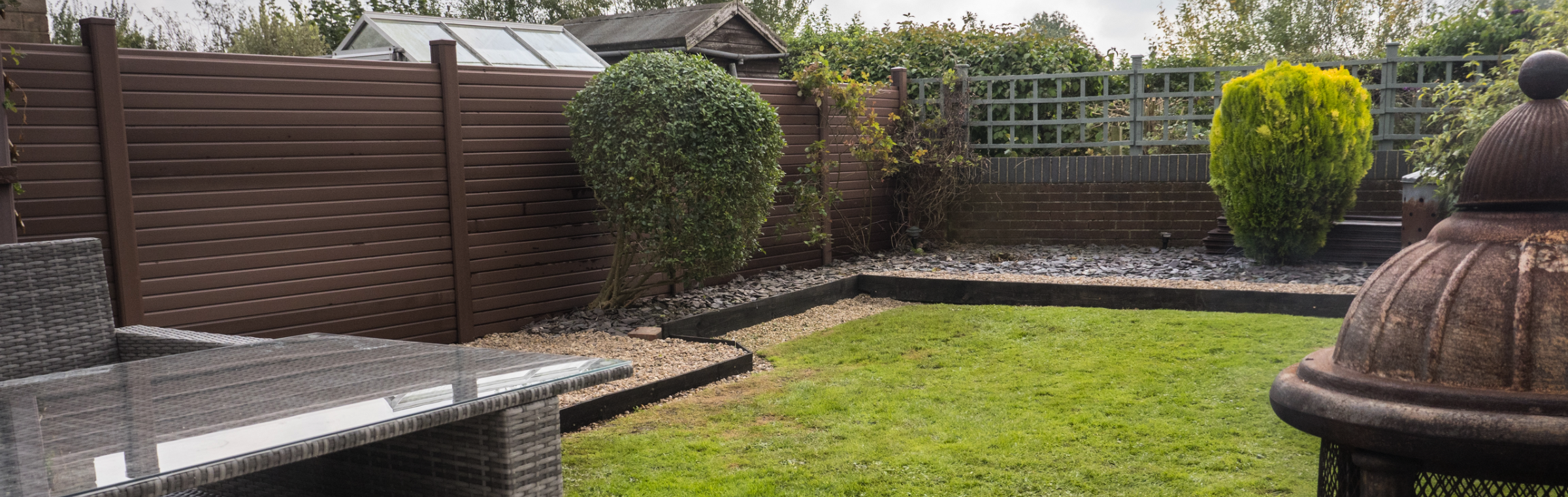 Creating a Low-Maintenance Outdoor Space with Fencing and Decking | Brown PVC Fencing installed in a Garden